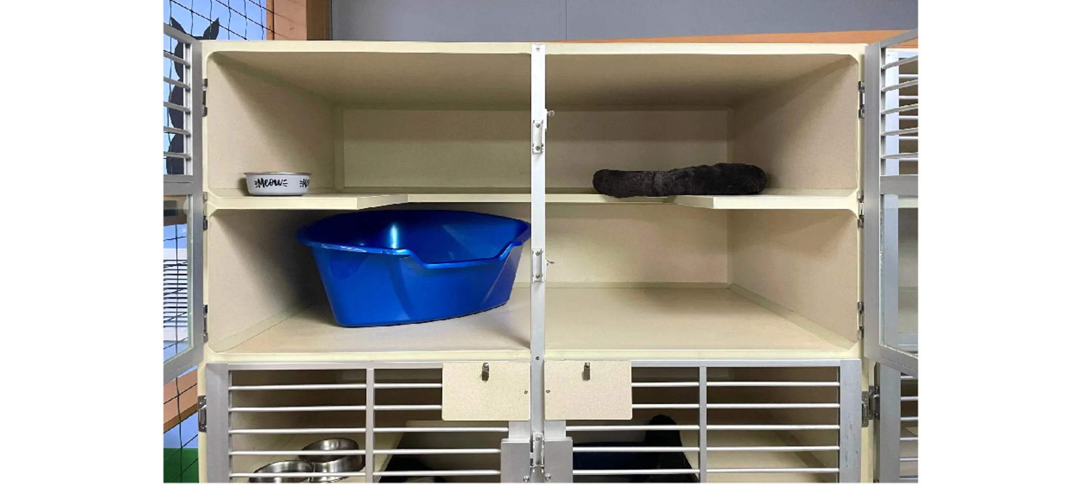 Condo space with a bowl and bed on top, and a litter box beneath